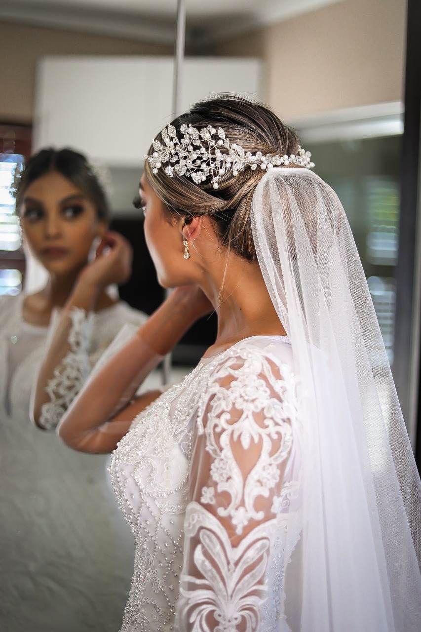 Bride in a hand-finished lace gown with intricate back detail