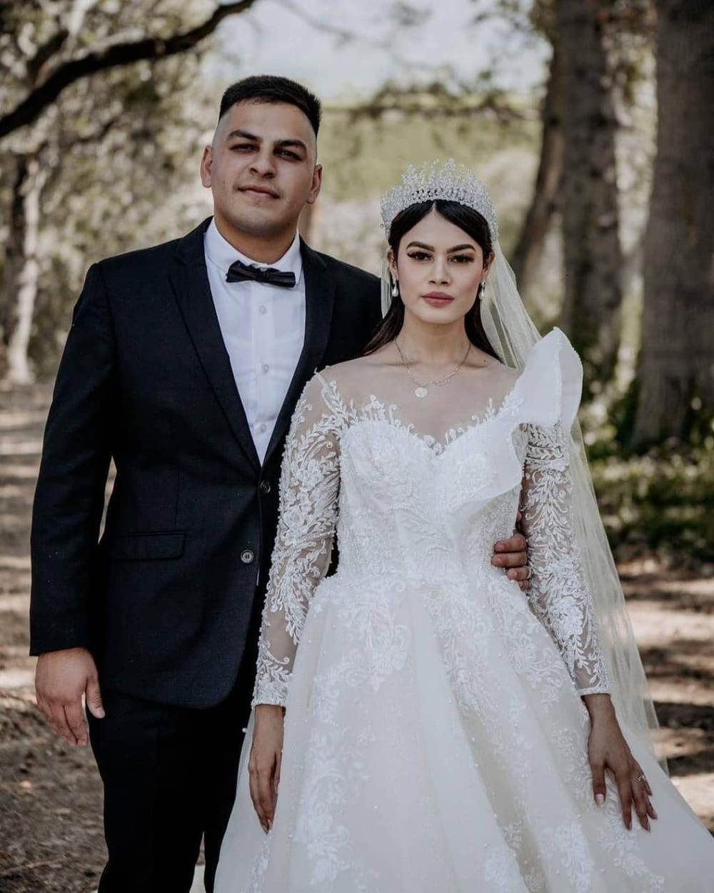 Bride in a beaded long sleeve gown photographed in a doorway