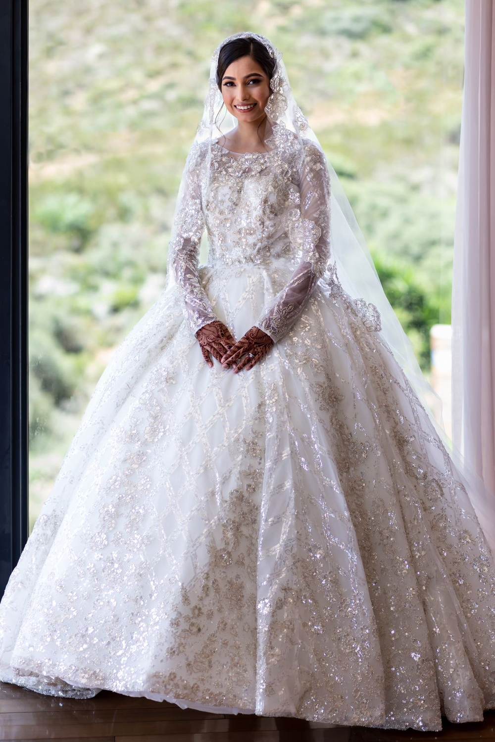 Real bride in a hand beaded long sleeve ball gown by Saarahjasmin Couture
