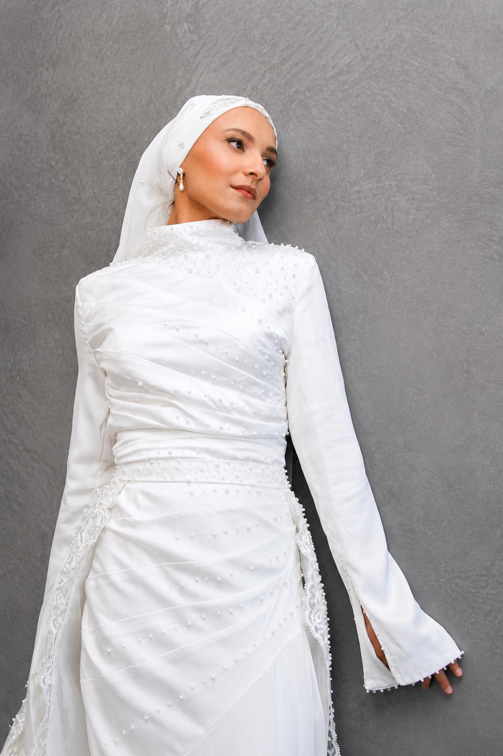 Modest bridal gown with long sleeves, high neckline and elegant train